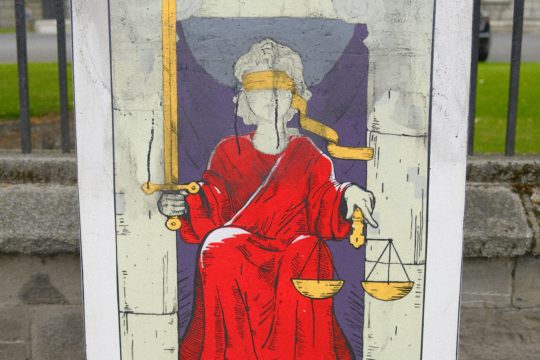 Illustration of lady justice holding scales of justice and sword